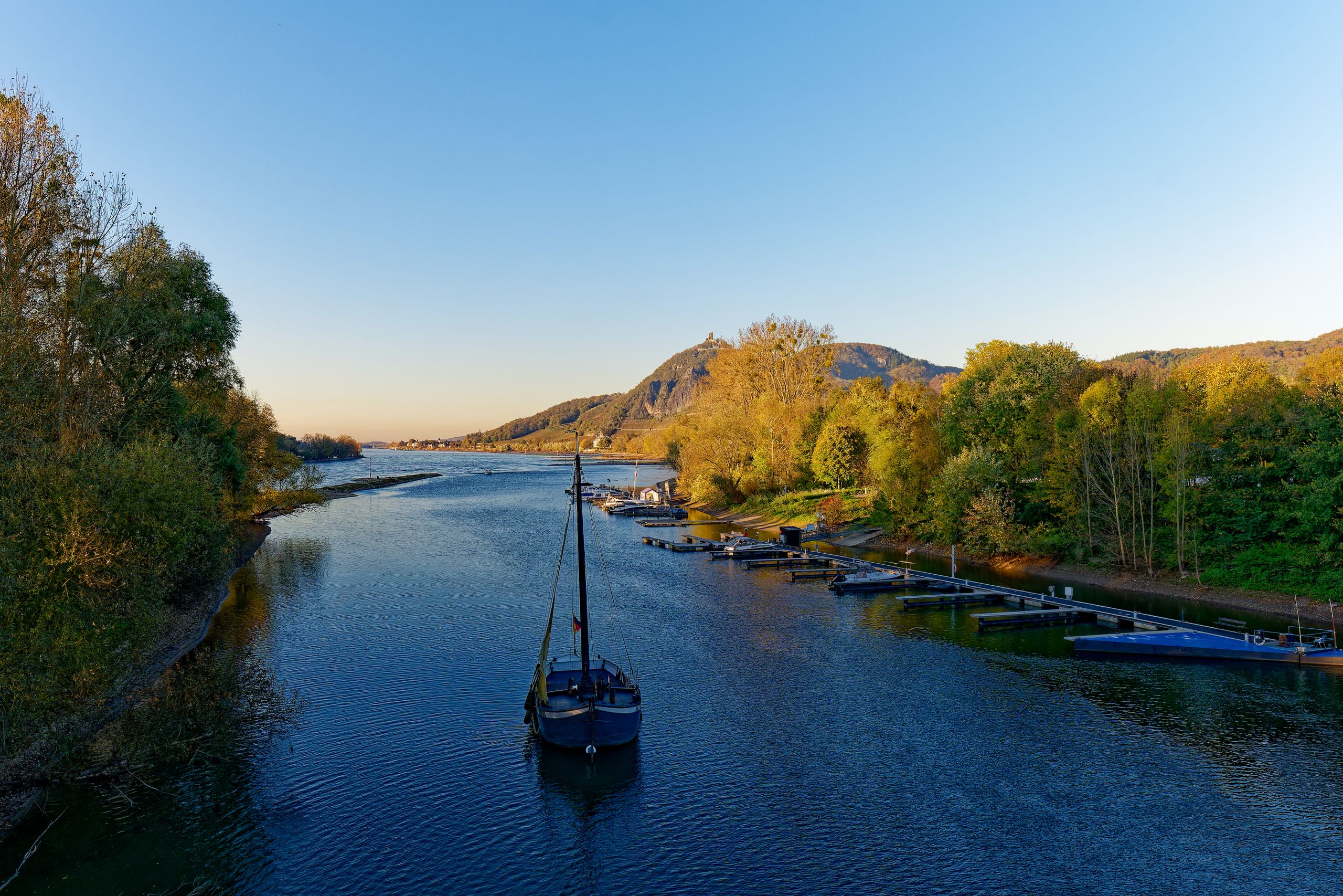 Tranquil scene of a boat on the Rhine River in Bad Honnef, Germany during sunset.