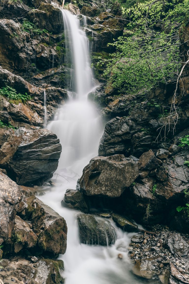 Tranquil waterfall cascading over rocks in lush Oberstdorf, Bavaria. Perfect for nature enthusiasts.