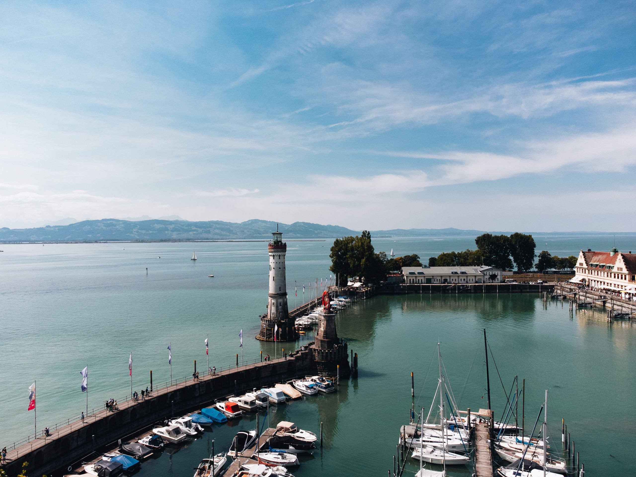 A breathtaking aerial view of the Lindau Lighthouse and marina on Lake Constance, Germany.