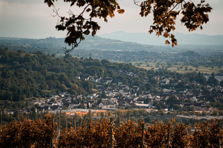 Picturesque autumn landscape overlooking a town in Baden-W&uuml;rttemberg surrounded by hills.